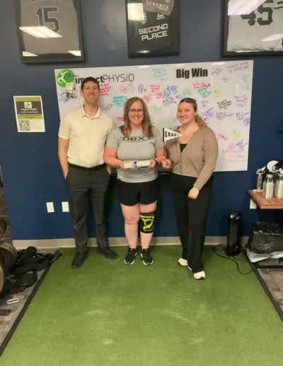 Impact Physio patient celebrating a recovery milestone with the care team