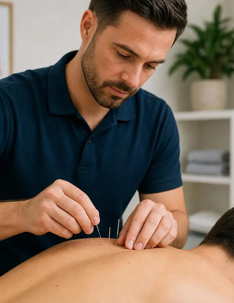 Physical therapist placing dry needles along a patient&rsquo;s upper back during treatment