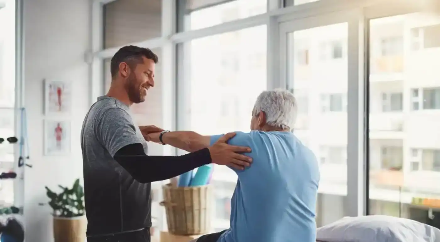 Physical therapist guiding a patient through a hands-on treatment session